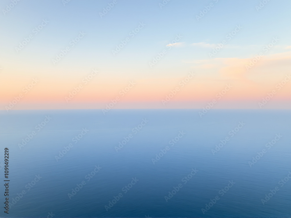 Aerial view of the ocean showcasing vibrant blue waters and gentle waves under a clear sky. Aerial view of the ocean showcasing vibrant blue waters and gentle waves under a clear sky.