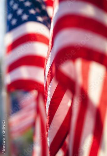 Close-up of American flags waving in the wind, showcasing patriotism and celebration.

 photo