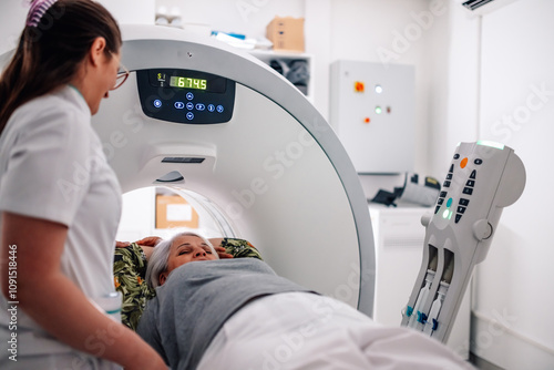 Fotografía Patient receiving care during CT scan with radiology technician.