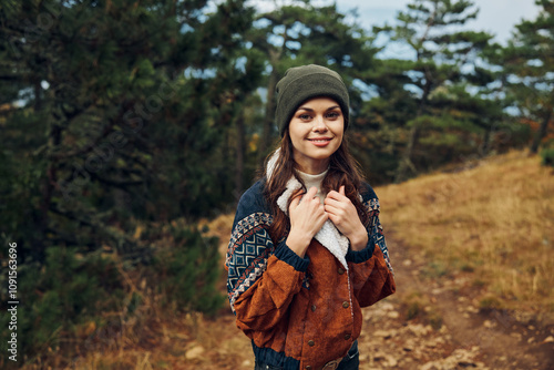 Beautiful young woman wearing a beanie enjoying nature in the forest Travel, fashion, beauty, portrait art concept photo