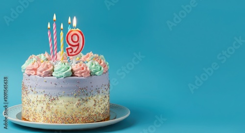 Birthday or anniversary cake with number 9 candle on blue background, perfect for ninth birthday or anniversary celebrations and special events
