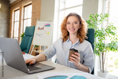 Photo of lovely young lady drink coffee work netbook dressed formalwear business manager comfortable startup office room interior photo