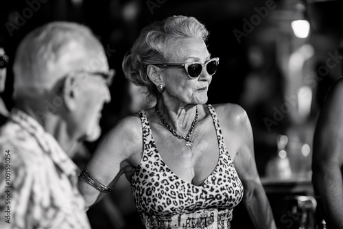 Black-and-White Image of Elderly People Dancing and Socializing at a Nightclub, Showcasing Joy and Timeless Energy photo