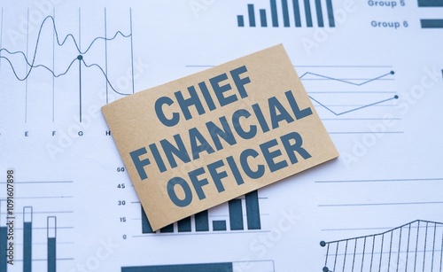 Chief Financial Officer job title on paper near graphs and charts