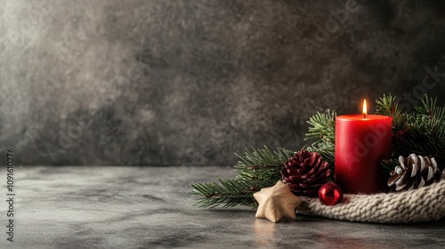 A festive red candle surrounded by pine branches, pinecones, and a star-shaped ornament, perfect for creating a warm holiday ambiance in any setting. photo