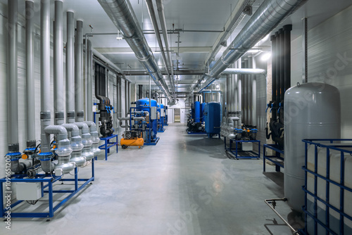 System for monitoring and maintaining temperature and humidity in production and storage facilities. Hall with industrial equipment.