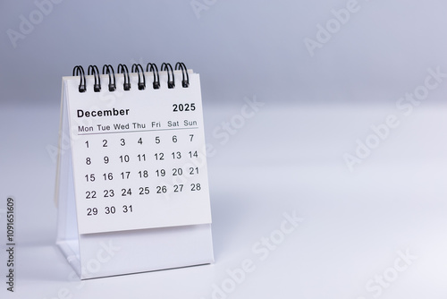December 2025 calendar - month page on white desk