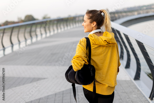 A joyful woman strolls alon...