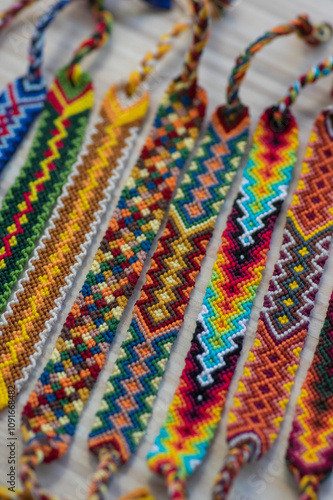 Group of handmade homemade colorful natural woven bracelets of friendship isolated on white background