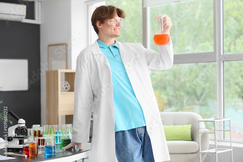 Male student in lab coat wi...
