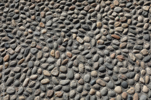 historic pedestrian paving with pebbles and smooth stones cemented into the city street photo