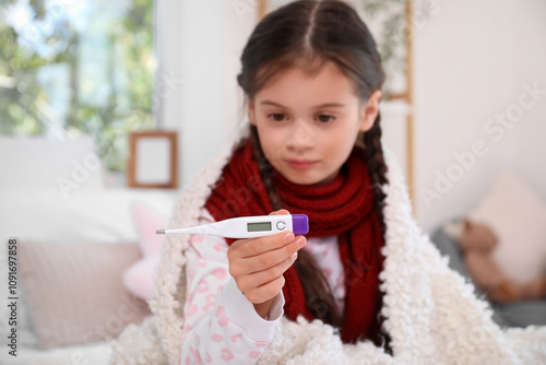Sick little girl with therm...