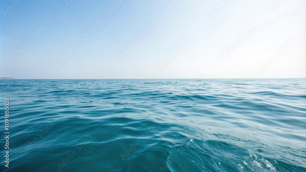 Fototapeta premium Softly gradient blue hues merge with gentle water ripples in the calm ocean surface, serene, peaceful, water texture