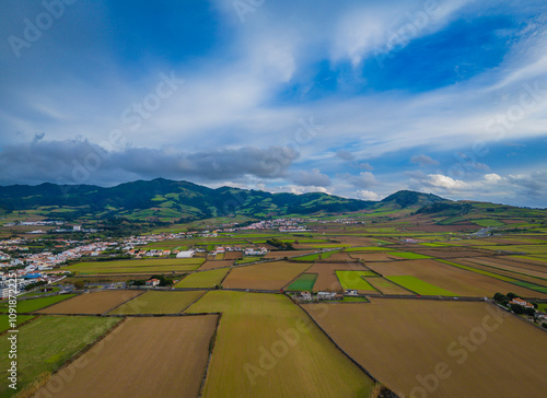 Sao Miguel Island scenic landscape with mountains and cultivated land in Azores, Portugal. Aerial drone view of panoramic Acores island photo