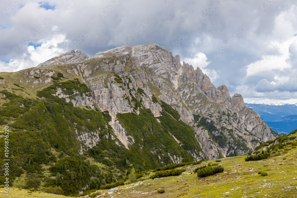 Fototapeta premium Dolomite mountains scenic landscape of towering rocky peaks in the Alps. High walls in the Alps from climbing and trekking path. Alpine route in the Dolomiti Alps surrounded by rock towers in Italy