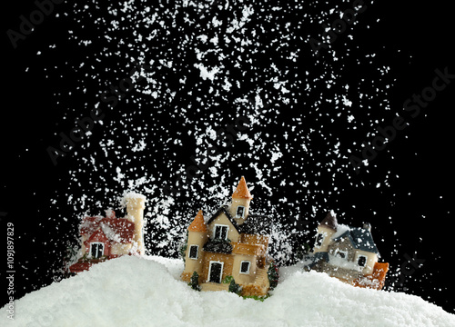 Snow fall cover house over black night background isolated. Winter snow storm falling on house like avalanche from climate change extreme weather disaster photo