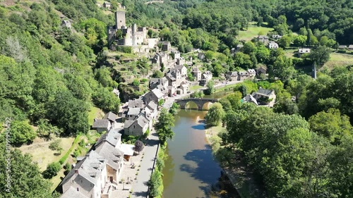 Wallpaper Mural Drone aerial view in France countryside small old medieval brick town and a castle on a green mountain forest stone bridge over a river in Belcastel Torontodigital.ca