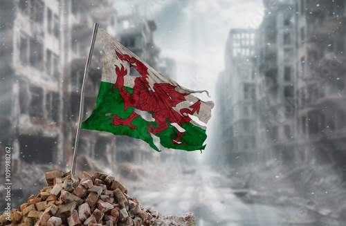 Dirty and torn Wales flag, symbol of resistance and victory. A scene of war and devastation, the ruins of a city destroyed by conflicts. 3D Rendering.