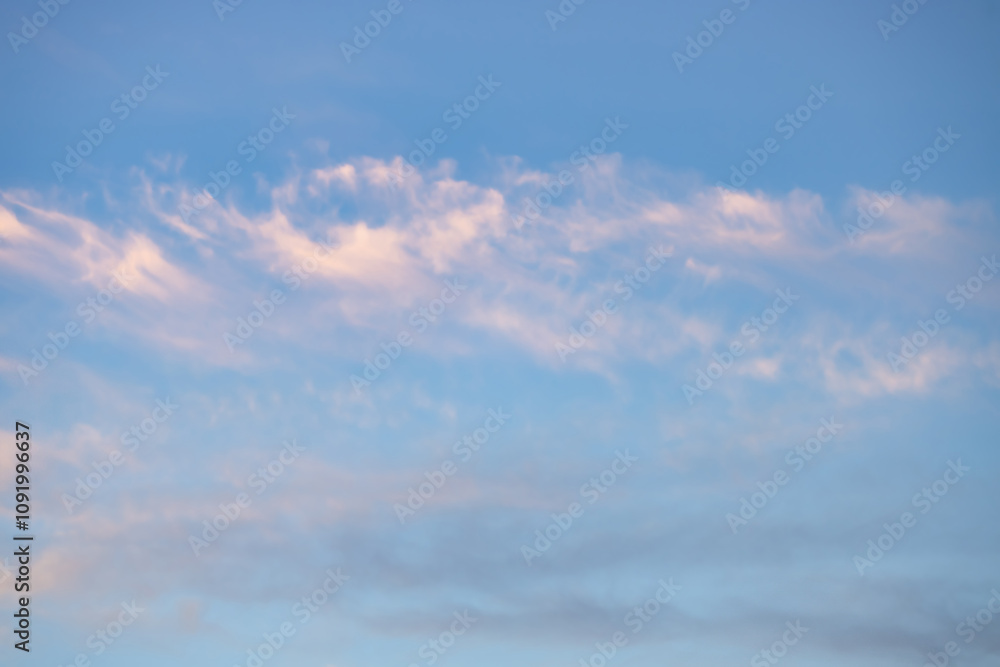 Obraz premium A beautiful sky tinted by the sun leaving vibrant shades of gold, pink, blue and multicolored. Clouds in the twilight evening and morning sky. Cloudy sky background in the evening, and during the day.