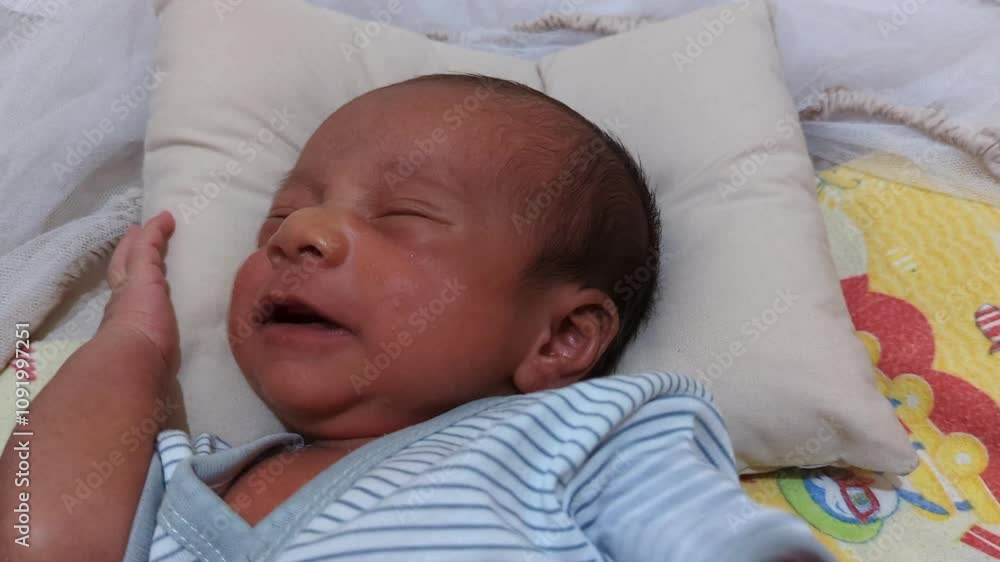 Newborn baby crying in a sleeping sack in a bed baby. Baby cocoon. Newborn boy in a sleeping blanket. Newborn baby crying in a sleeping sack in a bed baby. Baby cocoon. Newborn boy in a sleeping blanket.