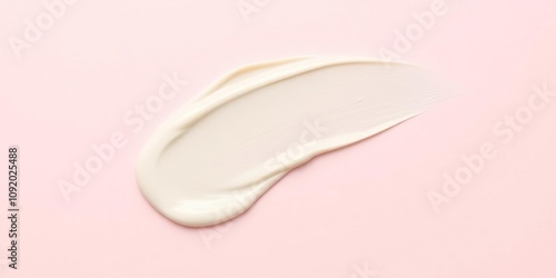 Creamy smear on a pale pink background with texture, gentle touch, natural ingredients, makeup application