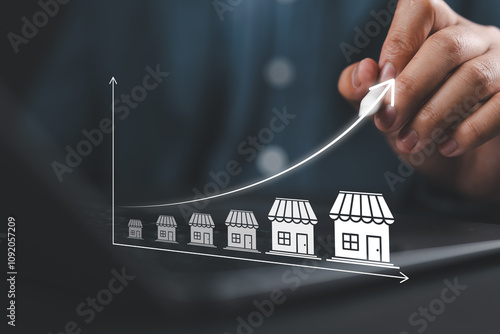 Franchise Business Growth and Expansion Strategy Visualization. Franchise concept. Entrepreneur visualizing franchise growth trajectory with increasing store icons on a digital upward trend graph. photo