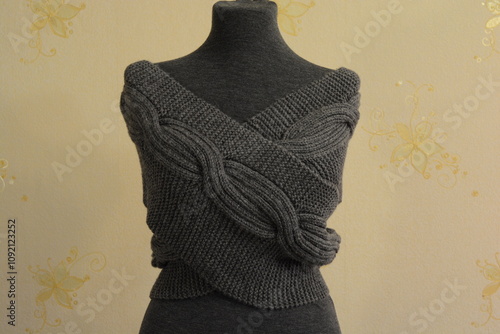 Snood knitted with dark gray yarn on a mannequin