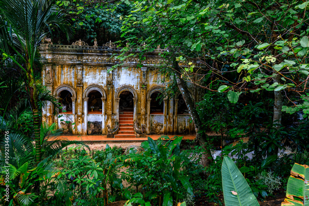 Obraz premium Natural background of ancient sculptures of religious tourist attractions, Naga statues, old churches by the natural waterfall from the high mountain, Wat Phalat, the way up to Doi Suthep, Chiang Mai