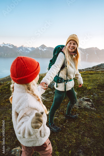 Mother and child hiking together follow holding hands travel in Norway, family vacations outdoor woman with kid healthy lifestyle active adventure tour - people backpackers exploring nature