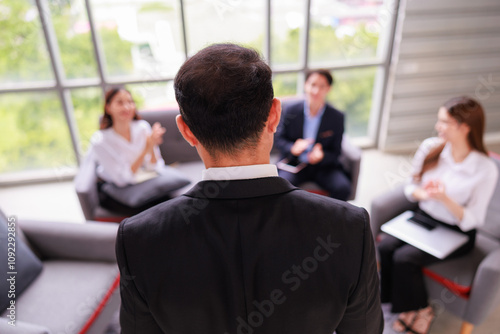 Asian Senior Manager Leading Team Discussion in a Corporate Office, Showcasing Leadership, Teamwork, and Strategy Development During a Professional Business Meeting with Engaged Employees