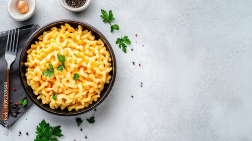 Delicious Creamy Macaroni and Cheese in a Black Bowl with Fresh Parsley on a Light Gray Background photo