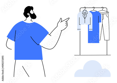 Bearded person in blue shirt pointing at a rack with hanging clothes. Ideal for fashion, personal style, wardrobe organization, retail, clothing stores, shopping, apparel merchandising