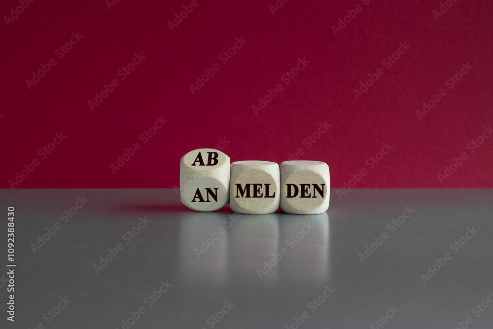 Turned dice and changes the German expression 'anmelden' (login) to 'abmelden' (logout). Beautiful red background, grey table. Business concept. Turned dice and changes the German expression 'anmelden' (login) to 'abmelden' (logout). Beautiful red background, grey table. Business concept.