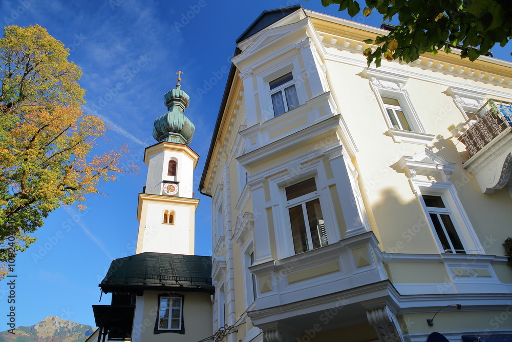 The church of Saint Egidius and a traditional house in Saint Gilgen, Wolfgangsee, Salzkammergut, Styria, Austria, Europe