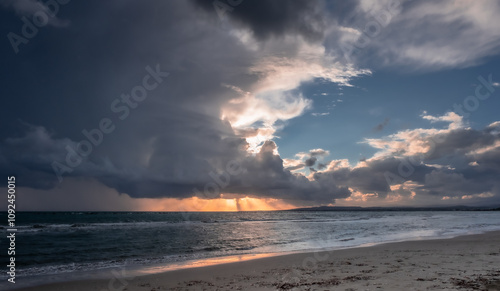 Heavy rain clouds at sunset hour by the sea in November as seen at the beach in Pervolia village, Larnaka District, Cyprus photo