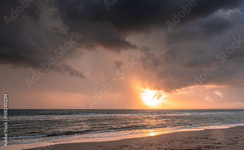 Heavy rain clouds at sunset hour by the sea in November as seen at the beach in Pervolia village, Larnaka District, Cyprus photo