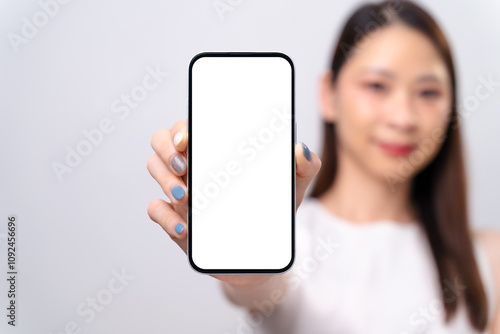 A woman is holding a phone with a white screen