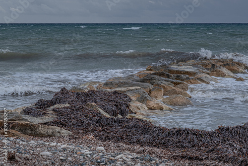 Sea coast view in a cloudy and rainy November day in Pervolia village, Larnaka District, Cyprus photo