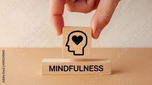 Wooden block with mindfulness symbol held in hand representing the practice of self awareness emotional balance and personal development for a healthy and fulfilling lifestyle photo