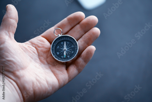 Travel concept. Magnetic compass in the hand. Retro navigator in hand a map and airplane background. Adventure Background.