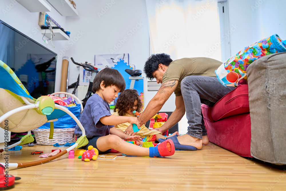 Fototapeta premium father playing with his two sons in the living room