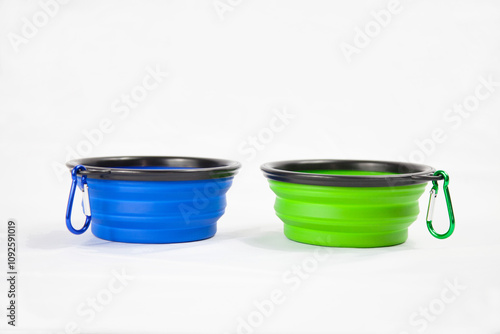 Vibrant collapsible pet bowls in blue and green with durable carabiners, ideal for travel and outdoor adventures