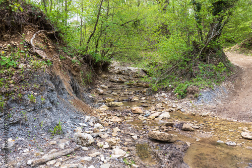 mountain river, spring day walks along the riverbed of a water barrier overlooking the river bottom