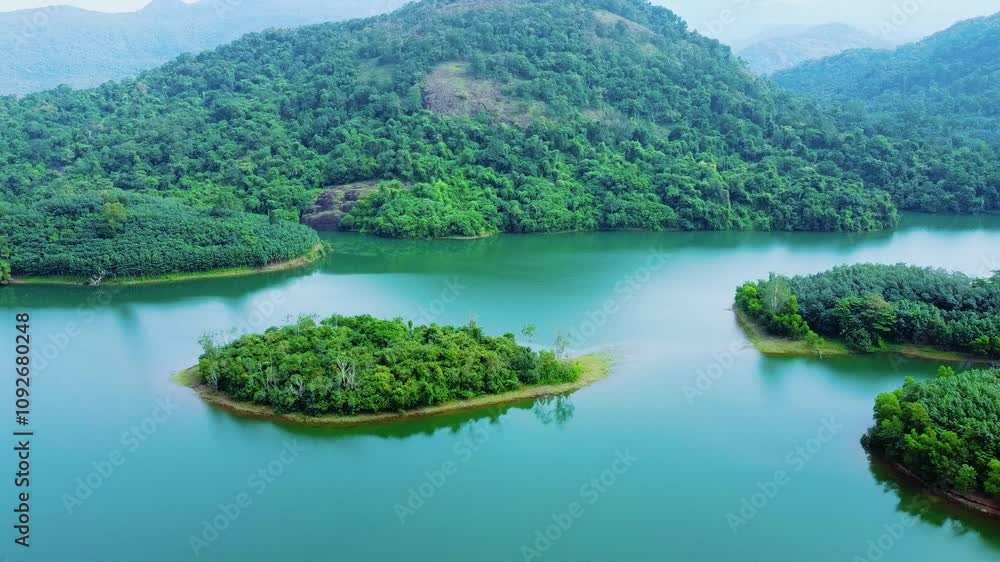 Areal view of a very beautiful tourist place, Morning view of Neyyar dam, Mountains and small green islands are seen in this video. Beautiful reservoir dam in Kerala, India, Areal view of a very beautiful tourist place, Morning view of Neyyar dam, Mountains and small green islands are seen in this video. Beautiful reservoir dam in Kerala, India,