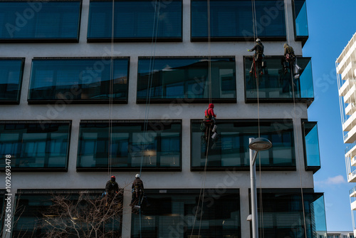 Workers Installing Pigeon Spikes on Skyscraper
