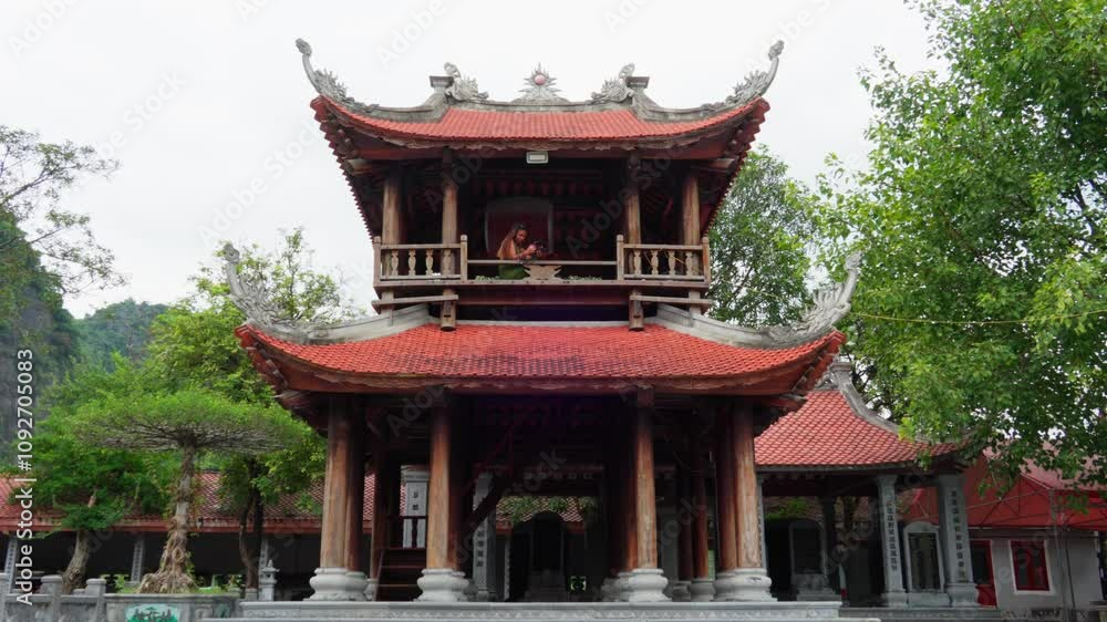 Serene vibe in a quiet buddhist temple, woman on top of shrine Serene vibe in a quiet buddhist temple, woman on top of shrine