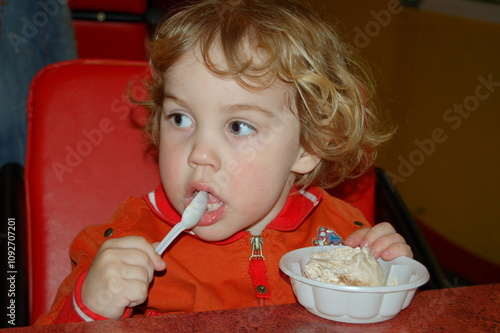 little boy eating cream