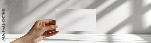 Hand holding a blank business card mockup. photo