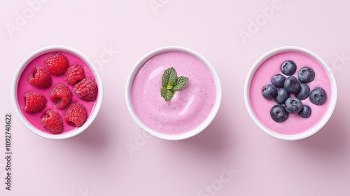 Assorted Berry Yogurt Bowls on Pastel Background with Fresh Fruit Toppings