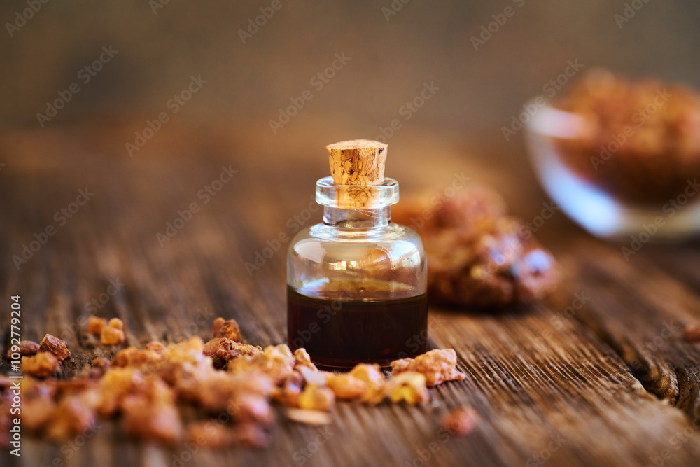 A bottle of myrrh essential oil with myrrh resin A bottle of myrrh essential oil with myrrh resin